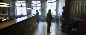 Movie still from “Kon-Tiki” (2012), directed by Espen Sandberg – Two men standing in front of a counter in a room; Wide shot, High angle