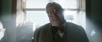 Movie still from “Kon-Tiki” (2012), directed by Espen Sandberg – An older man wearing a suit and bow tie; Close Up shot, Low angle