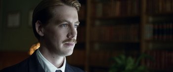 Movie still from “Kon-Tiki” (2012), directed by Espen Sandberg – A person wearing a suit and tie; Close Up shot, Low angle