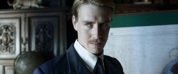 Movie still from “Kon-Tiki” (2012), directed by Espen Sandberg – A person wearing a suit and tie; Close Up shot, Low angle