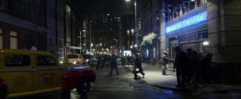 Movie still from “Kon-Tiki” (2012), directed by Espen Sandberg – A group of people walking across a street at night; Extreme Wide shot, High angle