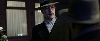 Movie still from “Kon-Tiki” (2012), directed by Espen Sandberg – A man wearing a hat and a suit; Close Up shot, Low angle