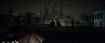 Movie still from “Kon-Tiki” (2012), directed by Espen Sandberg – Two people sitting on the roof of a building at night; Extreme Wide shot, High angle