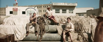 Movie still from “Kon-Tiki” (2012), directed by Espen Sandberg – A group of people sitting on top of a pile of rocks; Wide shot, Low angle