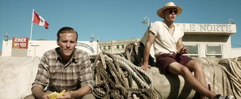 Movie still from “Kon-Tiki” (2012), directed by Espen Sandberg – Two men sitting next to a pile of ropes; Medium shot, Low angle
