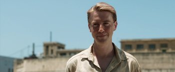 Movie still from “Kon-Tiki” (2012), directed by Espen Sandberg – A man with blonde hair wearing a tan shirt; Close Up shot, Low angle