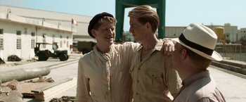 Movie still from “Kon-Tiki” (2012), directed by Espen Sandberg – Two young men standing next to each other on the street; Medium shot, Low angle