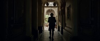 Movie still from “Kon-Tiki” (2012), directed by Espen Sandberg – A person is standing in a hallway looking out a window; Wide shot, Low angle