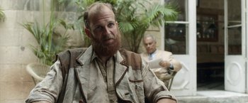 Movie still from “Kon-Tiki” (2012), directed by Espen Sandberg – A man with a long beard sitting next to another man; Medium shot, Over the shoulder angle