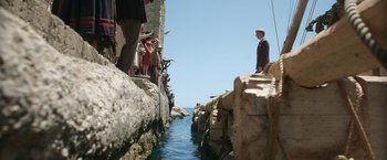 Movie still from “Kon-Tiki” (2012), directed by Espen Sandberg – A group of people standing next to a body of water; Extreme Wide shot, Low angle