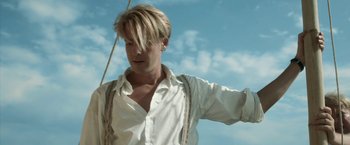Movie still from “Kon-Tiki” (2012), directed by Espen Sandberg – A man in a white shirt and suspenders on a sail boat; Close Up shot, Low angle