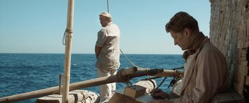 Movie still from “Kon-Tiki” (2012), directed by Espen Sandberg – Two men standing on a boat in the ocean; Medium shot, Over the shoulder angle