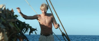 Movie still from “Kon-Tiki” (2012), directed by Espen Sandberg – A shirtless man on a boat with ropes; Medium shot, Low angle