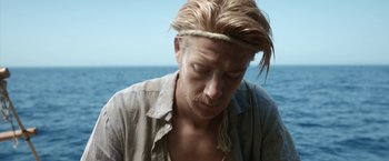 Movie still from “Kon-Tiki” (2012), directed by Espen Sandberg – A person with long blonde hair; Close Up shot, High angle