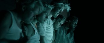 Movie still from “Kon-Tiki” (2012), directed by Espen Sandberg – A group of men standing next to each other in the dark; Medium shot, Low angle