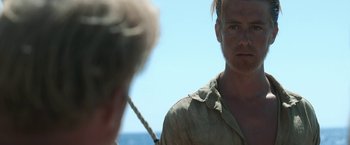 Movie still from “Kon-Tiki” (2012), directed by Espen Sandberg – A man in a tan shirt and a man in a white shirt looking at him; Close Up shot, Over the shoulder angle