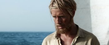 Movie still from “Kon-Tiki” (2012), directed by Espen Sandberg – A person with long hair and a beard; Close Up shot, Over the shoulder angle