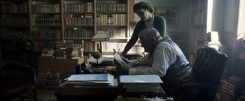 Movie still from “Kon-Tiki” (2012), directed by Espen Sandberg – A man and a woman working in a library; Medium shot, High angle
