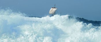 Movie still from “Kon-Tiki” (2012), directed by Espen Sandberg – A sail boat in the middle of a wave; Extreme Wide shot, High angle