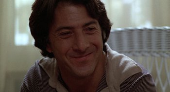 Movie still from “Kramer vs. Kramer” (1979), directed by Robert Benton – A person smiling; Close Up shot, Over the shoulder angle