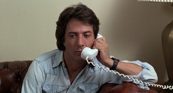 Movie still from “Kramer vs. Kramer” (1979), directed by Robert Benton – A man sitting on a couch talking on a phone; Close Up shot, Low angle