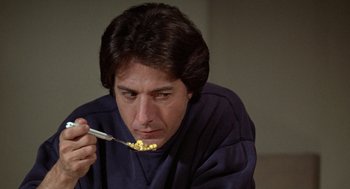 Movie still from “Kramer vs. Kramer” (1979), directed by Robert Benton – A man eating cereal while holding a spoon; Close Up shot, Low angle