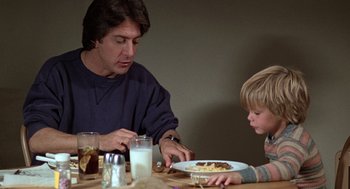 Movie still from “Kramer vs. Kramer” (1979), directed by Robert Benton – A man and a boy sitting at a dinner table; Medium shot, Over the shoulder angle