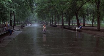 Movie still from “Kramer vs. Kramer” (1979), directed by Robert Benton – A person riding a motorcycle down a flooded street; Extreme Wide shot, High angle