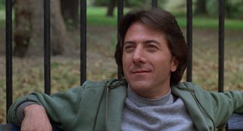 Movie still from “Kramer vs. Kramer” (1979), directed by Robert Benton – A person sitting in a chair near a fence; Close Up shot, Low angle