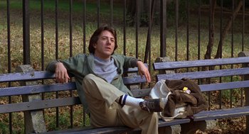 Movie still from “Kramer vs. Kramer” (1979), directed by Robert Benton – A man sitting on top of a wooden park bench; Medium shot, Low angle