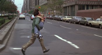 Movie still from “Kramer vs. Kramer” (1979), directed by Robert Benton – A man carrying a woman across a street; Wide shot, High angle