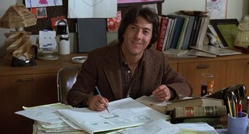 Movie still from “Kramer vs. Kramer” (1979), directed by Robert Benton – A man sitting at a desk with a pen and paper; Medium shot, High angle