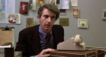 Movie still from “Kramer vs. Kramer” (1979), directed by Robert Benton – A man sitting at a desk in front of a phone; Close Up shot, Low angle