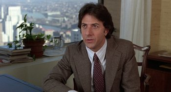 Movie still from “Kramer vs. Kramer” (1979), directed by Robert Benton – A person wearing a suit and tie; Close Up shot, Over the shoulder angle
