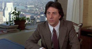 Movie still from “Kramer vs. Kramer” (1979), directed by Robert Benton – A person wearing a suit and tie; Close Up shot, Over the shoulder angle