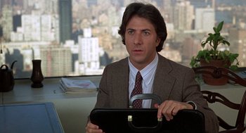 Movie still from “Kramer vs. Kramer” (1979), directed by Robert Benton – A man in a suit and tie holding a briefcase; Medium shot, Over the shoulder angle