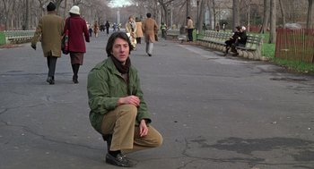 Movie still from “Kramer vs. Kramer” (1979), directed by Robert Benton – A man squatting on the sidewalk of a park; Medium shot, Low angle