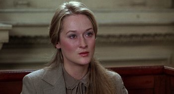 Movie still from “Kramer vs. Kramer” (1979), directed by Robert Benton – A person wearing a suit and tie; Close Up shot, Over the shoulder angle