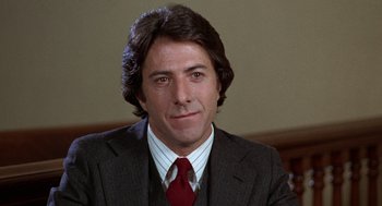Movie still from “Kramer vs. Kramer” (1979), directed by Robert Benton – A person wearing a suit and tie; Close Up shot, Low angle