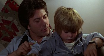 Movie still from “Kramer vs. Kramer” (1979), directed by Robert Benton – A man and a boy are looking at something on a phone; Close Up shot, Over the shoulder angle