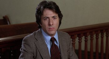 Movie still from “Kramer vs. Kramer” (1979), directed by Robert Benton – A person wearing a suit and tie; Close Up shot, Low angle