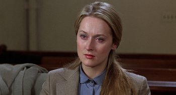 Movie still from “Kramer vs. Kramer” (1979), directed by Robert Benton – A woman with long blonde hair wearing a suit; Close Up shot, Over the shoulder angle