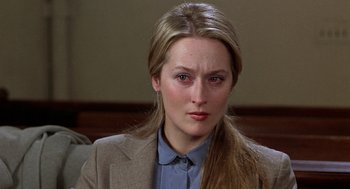 Movie still from “Kramer vs. Kramer” (1979), directed by Robert Benton – A person wearing a suit and tie; Close Up shot, Over the shoulder angle