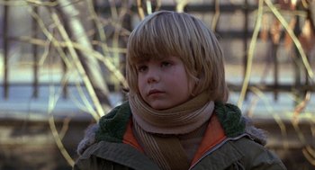 Movie still from “Kramer vs. Kramer” (1979), directed by Robert Benton – A little boy with blonde hair wearing a green jacket; Close Up shot, Low angle