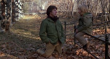 Movie still from “Kramer vs. Kramer” (1979), directed by Robert Benton – A man kneeling down next to a woman in a park; Medium shot, Over the shoulder angle