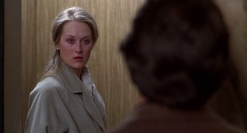 Movie still from “Kramer vs. Kramer” (1979), directed by Robert Benton – A young woman looking into a mirror in front of a man; Close Up shot, Over the shoulder angle