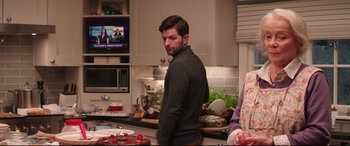 Movie still from “Krampus” (2015), directed by Michael Dougherty – A man standing in a kitchen next to a counter; Medium shot, Over the shoulder angle