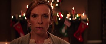 Movie still from “Krampus” (2015), directed by Michael Dougherty – A person wearing a sweater; Close Up shot, Over the shoulder angle