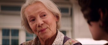 Movie still from “Krampus” (2015), directed by Michael Dougherty – An older woman with white hair and a floral shirt; Close Up shot, Over the shoulder angle