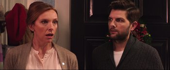 Movie still from “Krampus” (2015), directed by Michael Dougherty – A woman and a man standing next to each other; Close Up shot, Over the shoulder angle